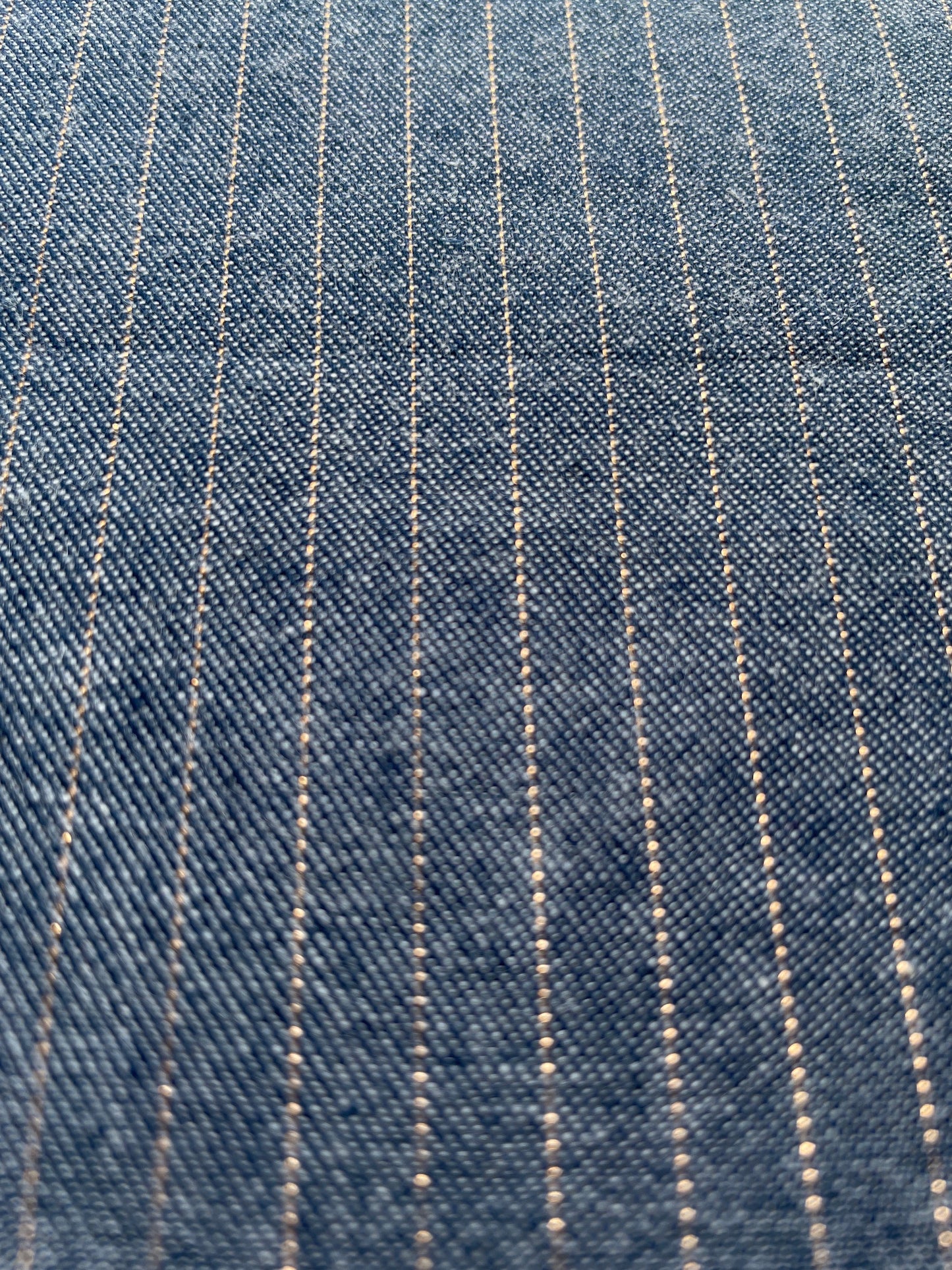 Blue denim fabric with a copper metallic horizontal stripe