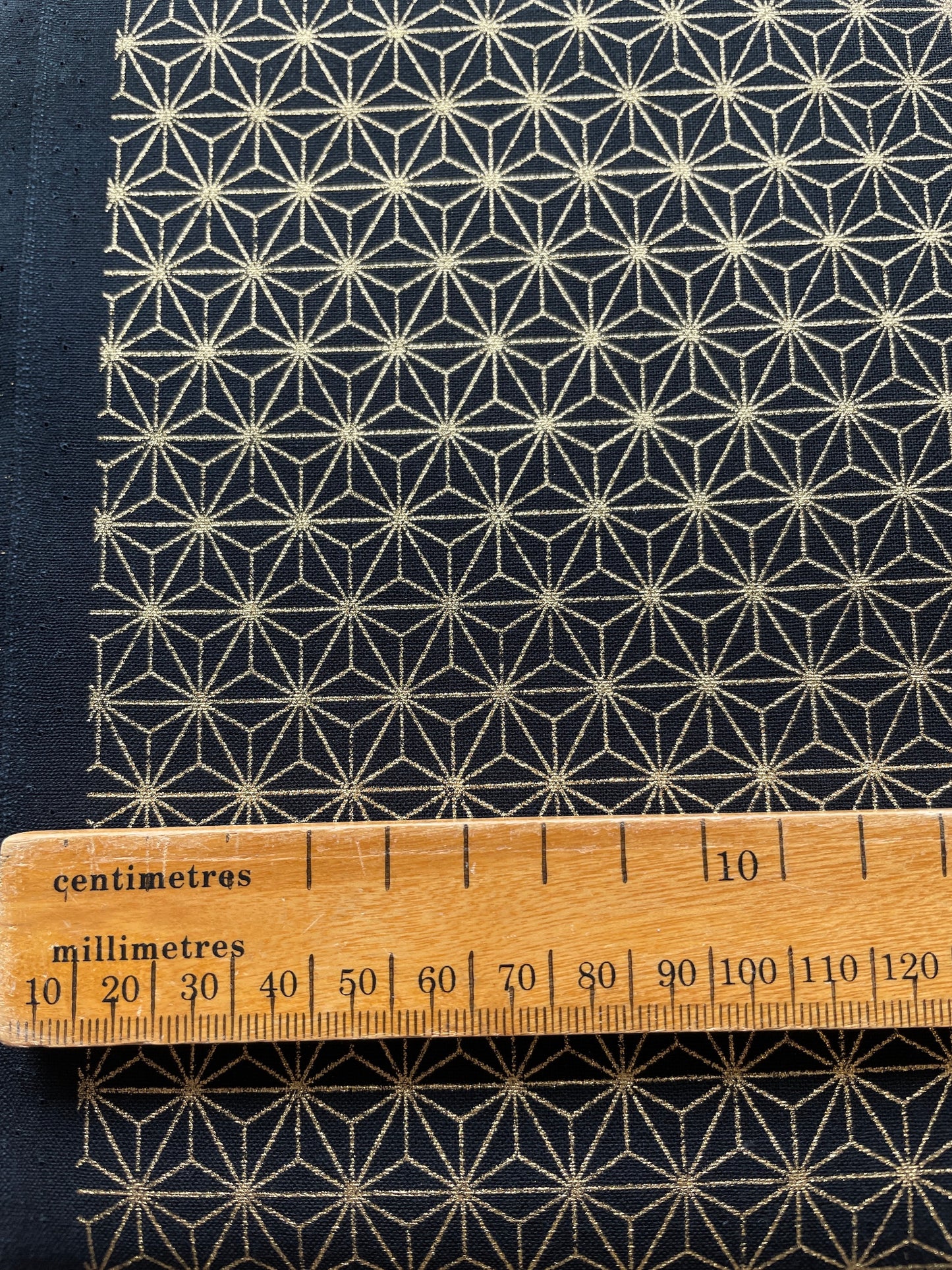 Geometric gold star cotton fabric