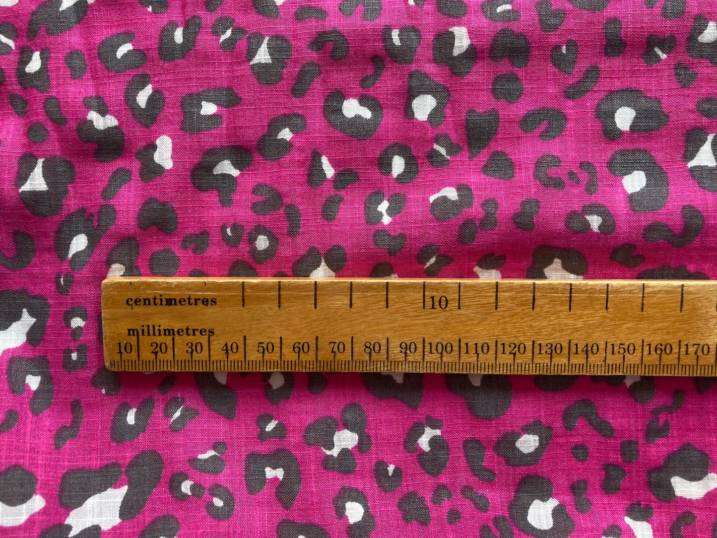 Linen look cerise pink leopard print fabric